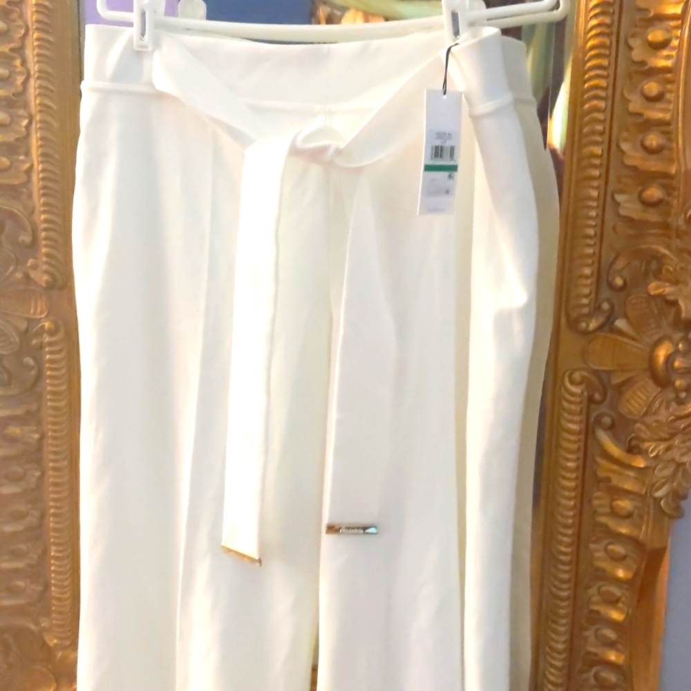 White wide leg pants with gold trim waist tie.